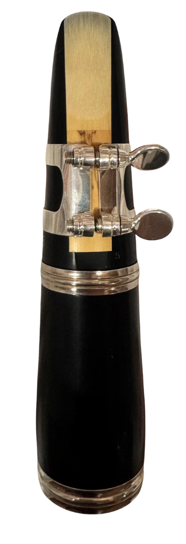 Ligature positioned around the thick section of the reed, with screws on the right